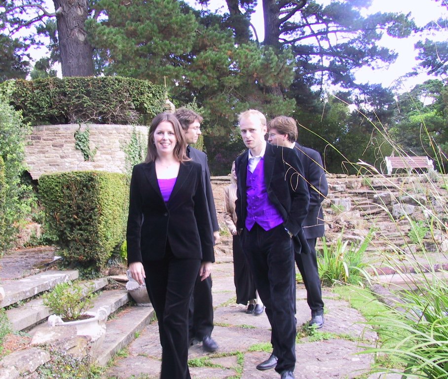 Members of TONUS PEREGRINUS walking through a garden